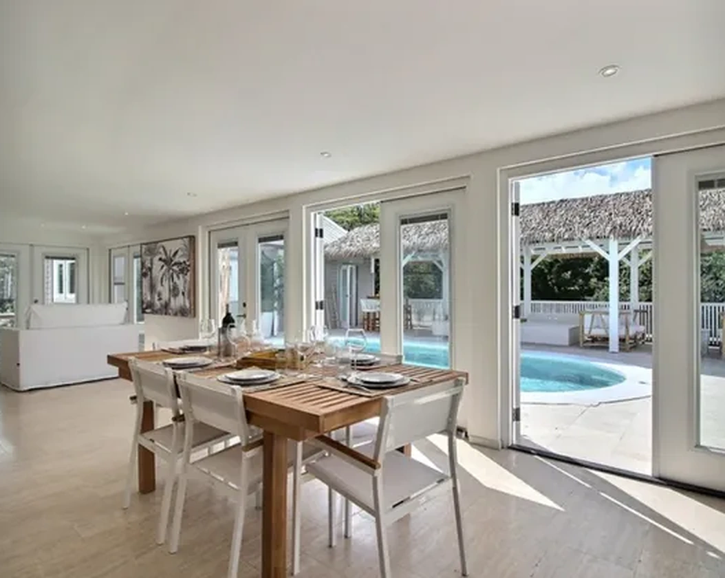 The dining room opening onto the pool