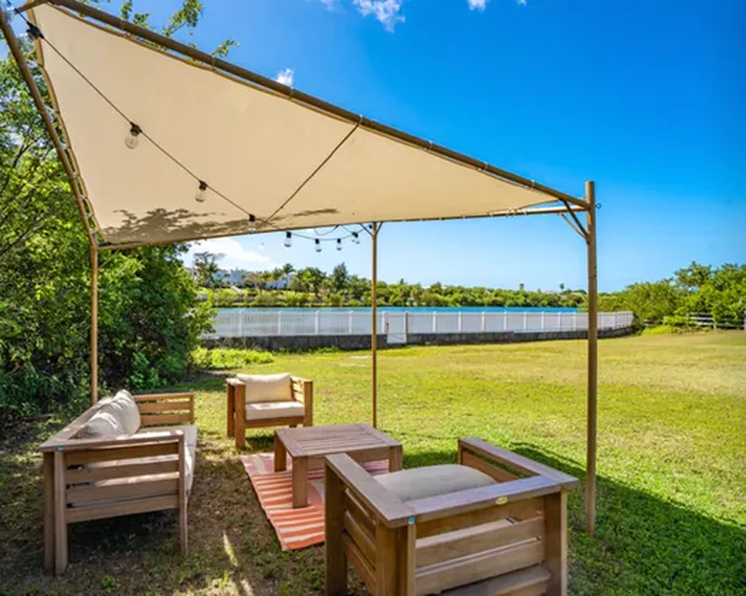 Garden seating beneath the shade sail
